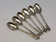A collection of six ornate silver spoons