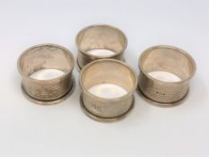 A set of four silver napkin rings