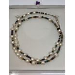 A cultured pearl necklace with 9ct rose gold clasp, strung with emerald,