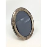 A large oval silver photograph frame 17.5 cm x 22.5 cm.