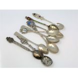 Nine assorted silver and enamel spoons.