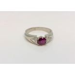 An 18ct white gold ruby and diamond ring, approximately 0.5ct, size K.