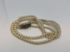 A 14 inch double strand of pearls on silver marcasite clasp