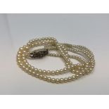 A 14 inch double strand of pearls on silver marcasite clasp