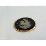 An antique Wedgwood brooch in yellow gold frame