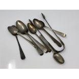 A selection of Georgian silver spoons and tongs.