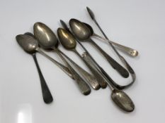 A selection of Georgian silver spoons and tongs.
