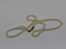 A 16 inch strand of pearls on a yellow gold clasp