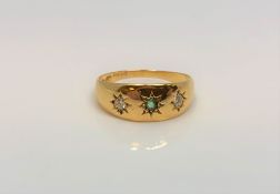 An 18ct gold emeral and two stone diamond ring, size J.