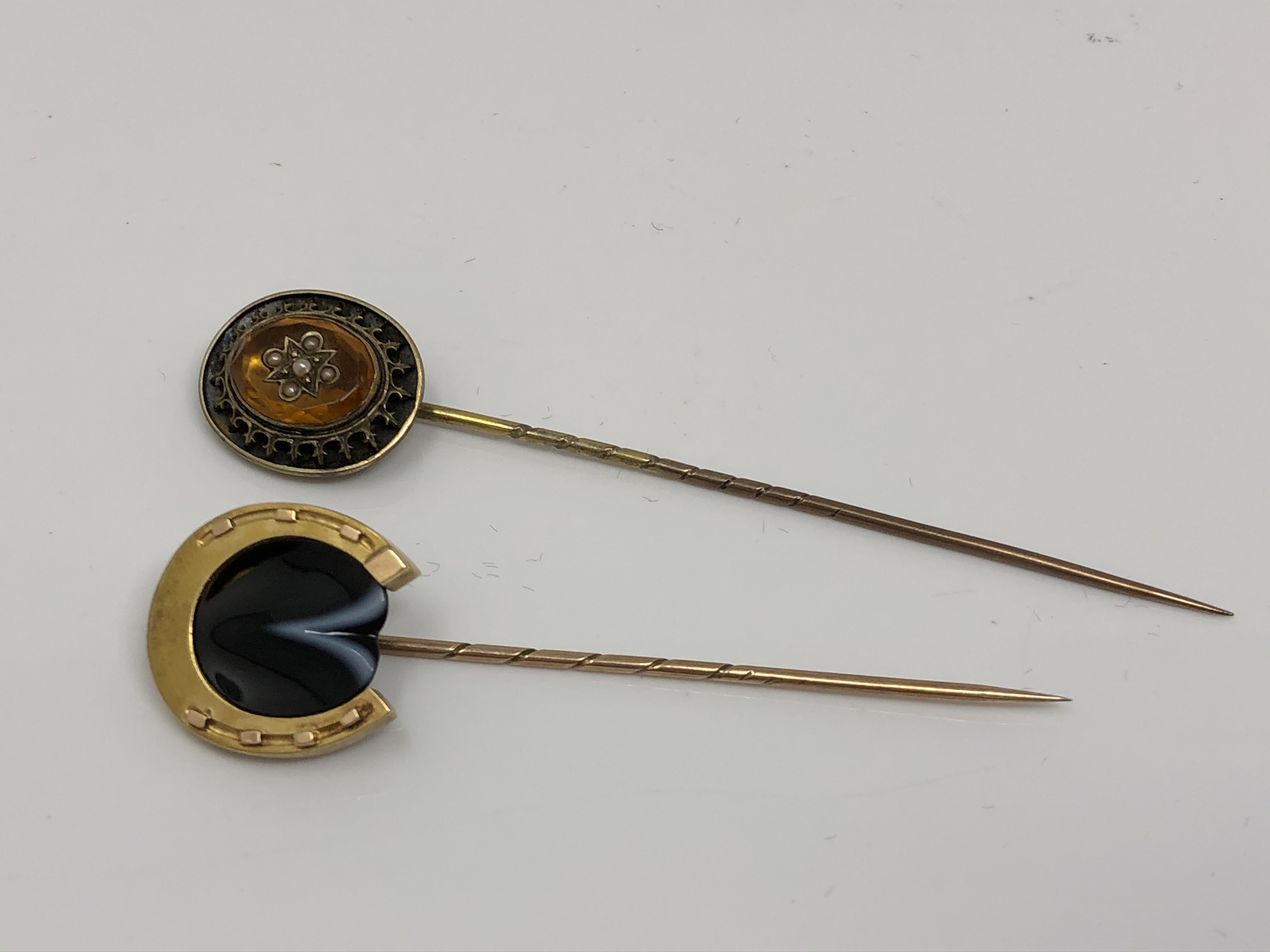 Two 15ct gold stick pins;