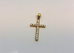 An 18ct yellow gold diamond cross pendant, the seventeen diamonds approximately 0.6ct.