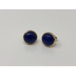 A pair of 9ct gold cabochon lapis lazuli earrings with post fittings.