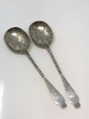 A pair of ornate Victorian silver serving spoons,