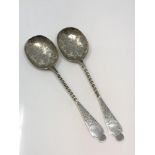 A pair of ornate Victorian silver serving spoons,