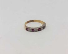 A ruby and diamond half eternity ring, 18CT size O.