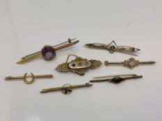 A group of seven gold brooches set with opal, amethyst, seed pearls,