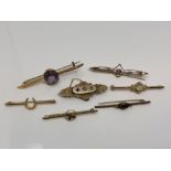 A group of seven gold brooches set with opal, amethyst, seed pearls,