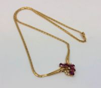 An 18ct gold ruby and diamond necklace, 12.45g. CONDITION REPORT: Chain length 42 cm.