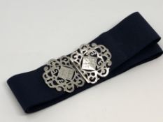 A silver nurse's buckle on belt