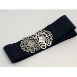 A silver nurse's buckle on belt