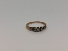 An 18ct gold three stone diamond ring, size I CONDITION REPORT: 1.