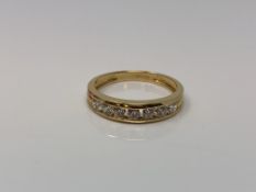 An 18ct gold half eternity dress ring, size P1/2 CONDITION REPORT: 3.