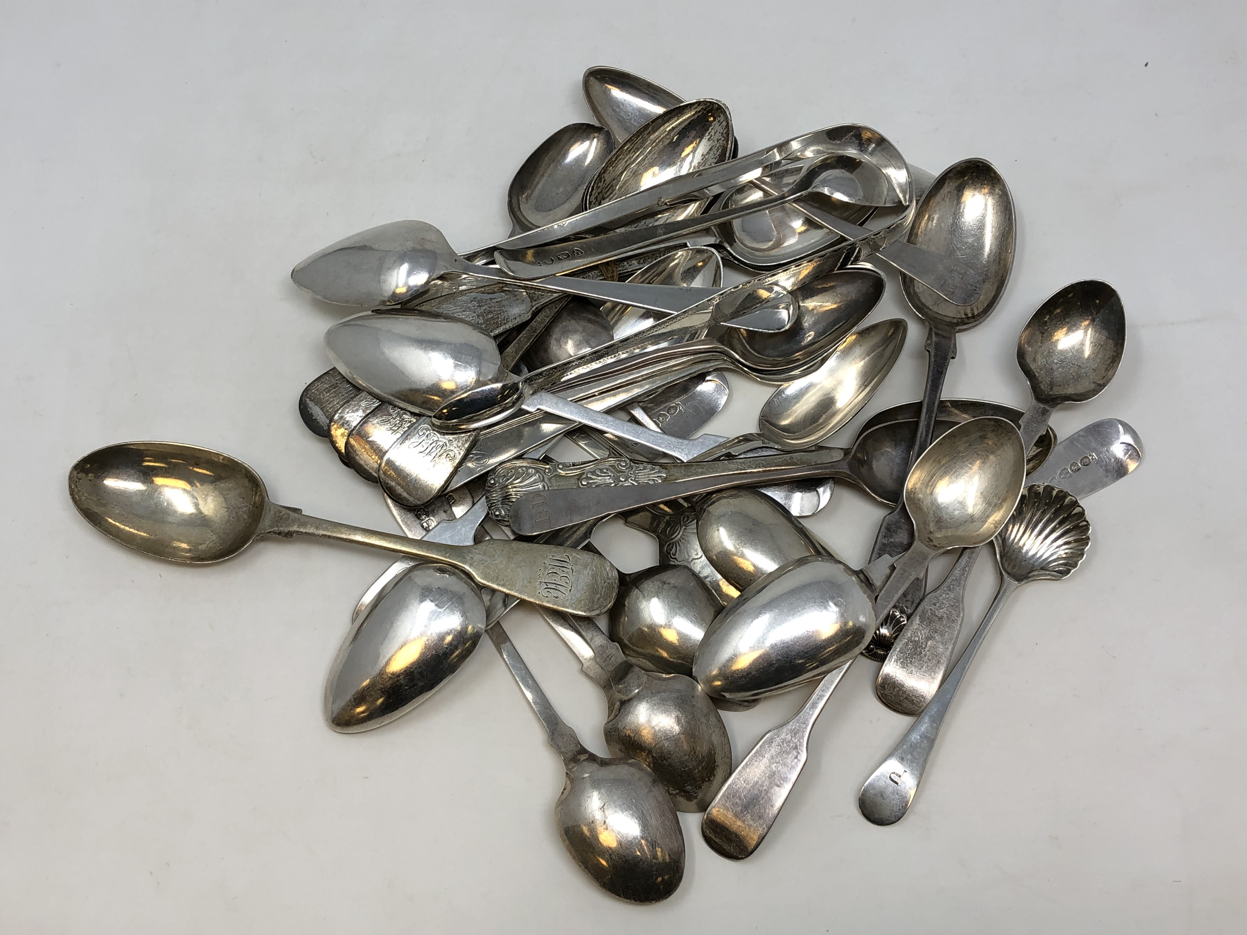 A large quantity of Newcastle silver spoons and sugar nips etc. Gross weight 543g.