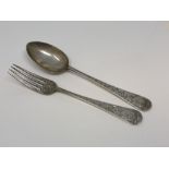 An ornate silver fork and spoon,