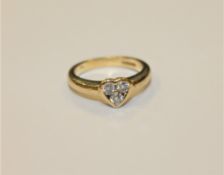 An 18ct gold diamond ring in heart shaped setting, approximately 0.3ct, Size I.