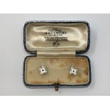A pair of boxed 9ct white gold studs set with sapphire and mother of pearl