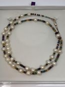 A cultured pearl necklace with 9ct rose gold clasp, strung with emerald,