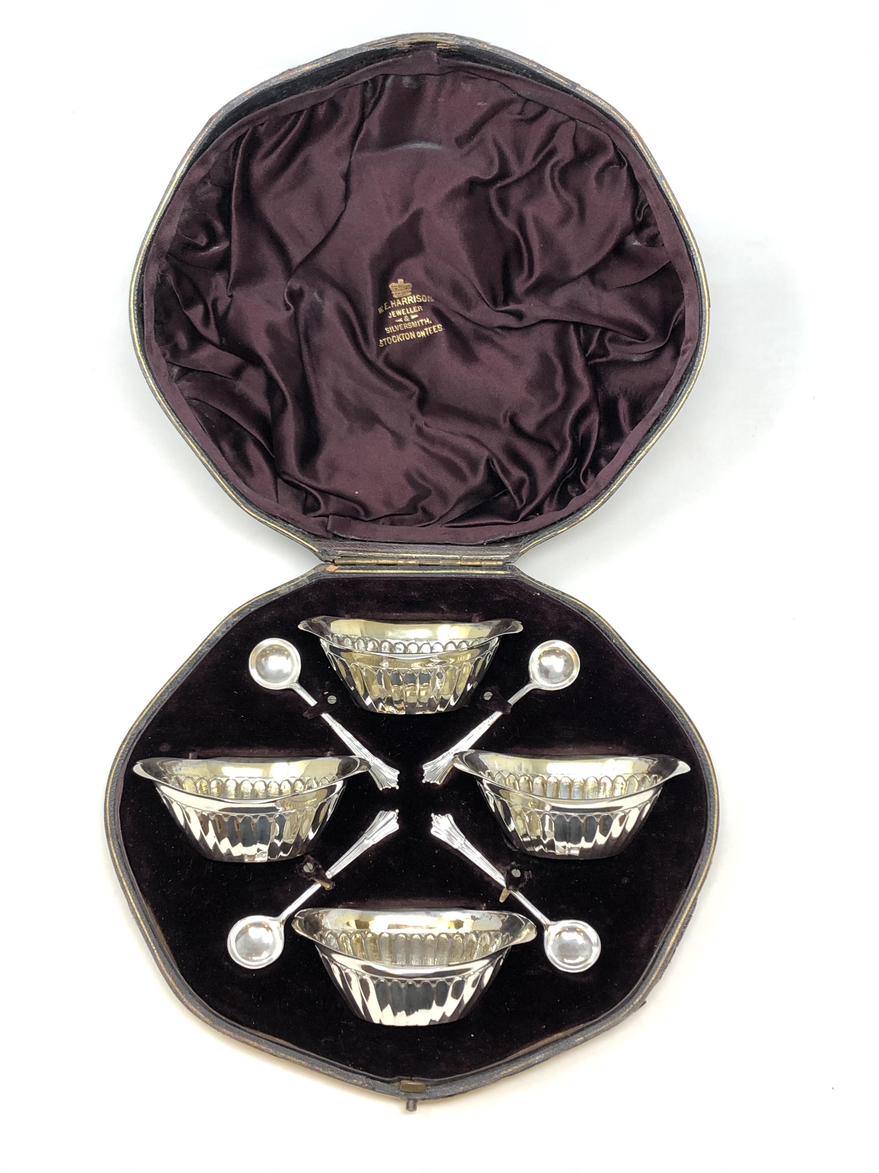 A boxed set of four Victorian silver gilt salts and spoons,