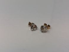 A pair of 14ct white gold CZ set stud earrings with yellow gold backings.