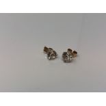 A pair of 14ct white gold CZ set stud earrings with yellow gold backings.