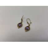 A pair of 9ct gold amethyst drop earrings. CONDITION REPORT: 1.