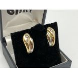 A pair of 18ct yellow and white gold diamond set earrings CONDITION REPORT: 7.