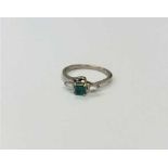 An 18ct gold emerald and diamond ring,