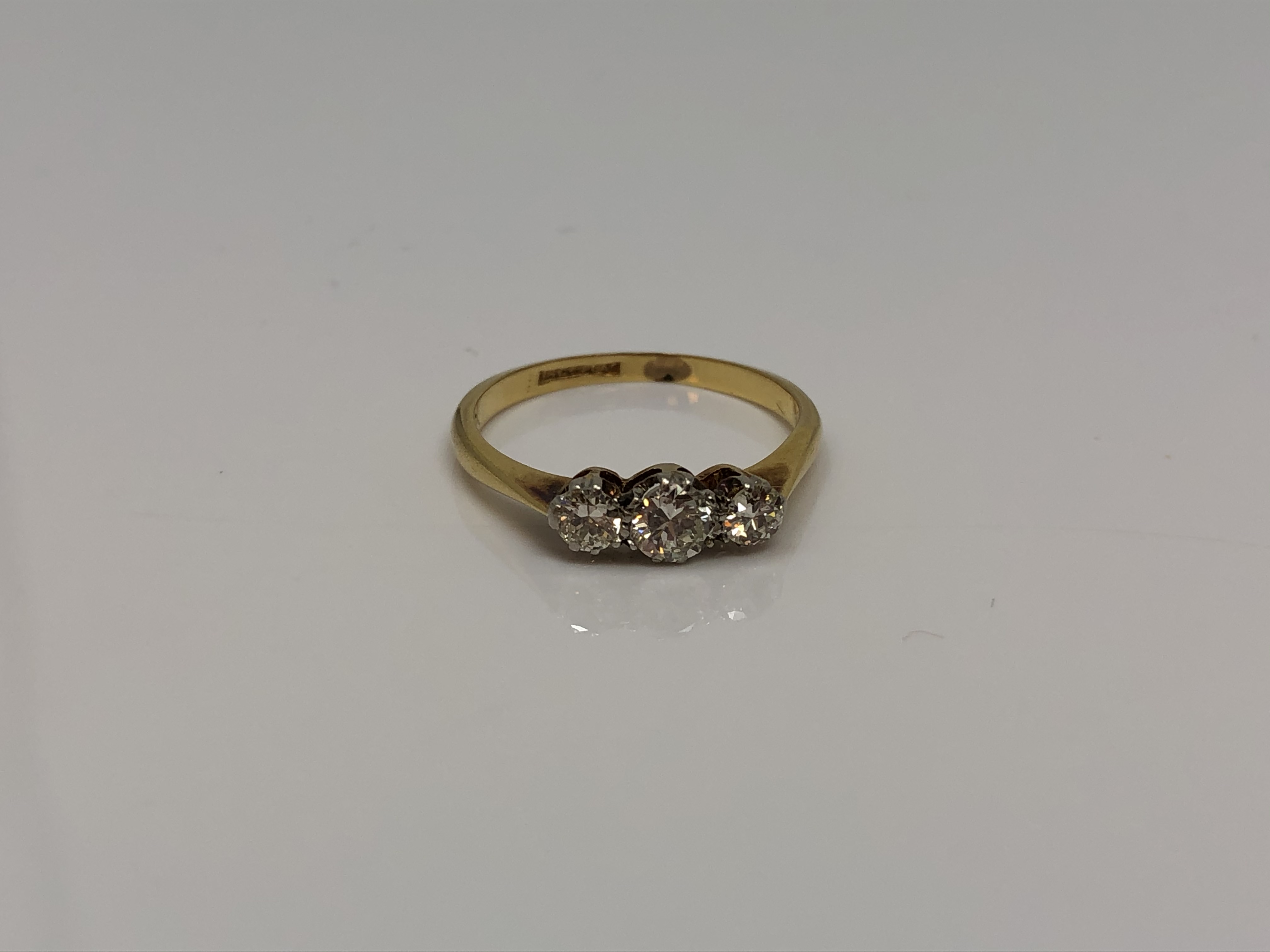 An antique 18ct gold three stone diamond ring, approx. 0.