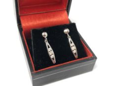 A pair of 9ct white gold CZ set drop earrings. CONDITION REPORT: 1.