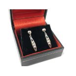 A pair of 9ct white gold CZ set drop earrings. CONDITION REPORT: 1.