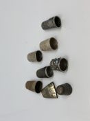 A group of four silver and other white metal thimbles