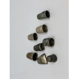 A group of four silver and other white metal thimbles