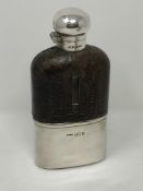 An Edwardian silver and leather mounted glass hip flask,