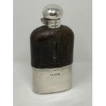 An Edwardian silver and leather mounted glass hip flask,