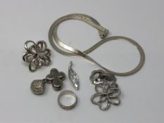 A group of silver jewellery to include an articulated necklace, various pendants,