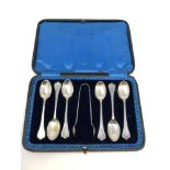 A boxed set of silver spoons and tongs,