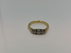 An 18ct gold three stonme diamond ring, size M CONDITION REPORT: 2.