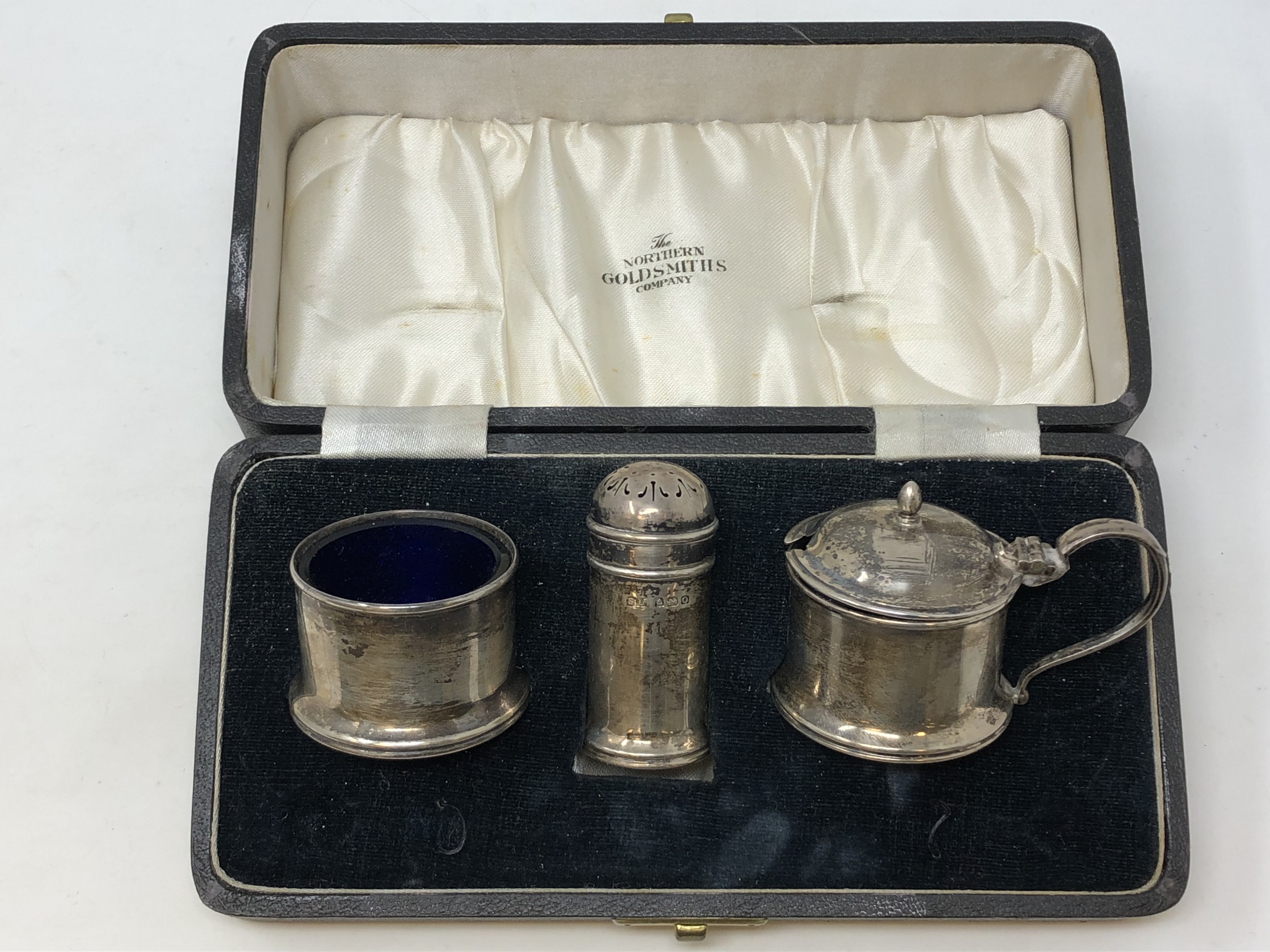 A boxed three piece silver condiment set