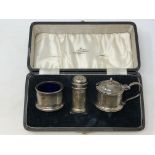 A boxed three piece silver condiment set