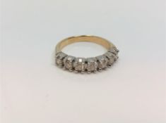 An 18ct white gold seven stone diamond half eternity ring, approximately 0.7ct, size P.